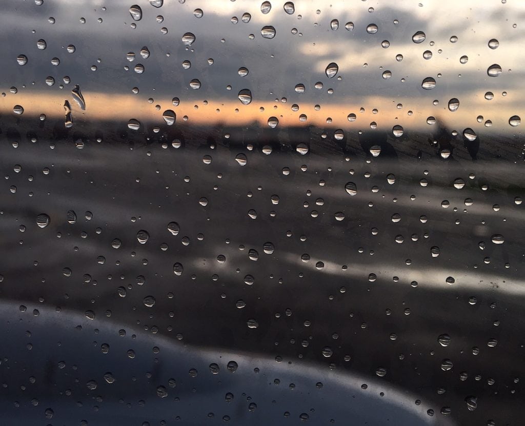 A rainy sunset as seen from a plane at Newark Airport. - "The Best Options for Traveling Between Manhattan and Newark Airport (EWR)" - Two Traveling Texans